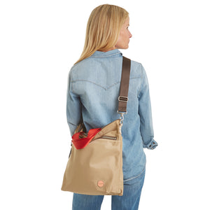 shortyLOVE wonder large crossbody/messenger bag in khaki; on model in jean top and jeans against white background.