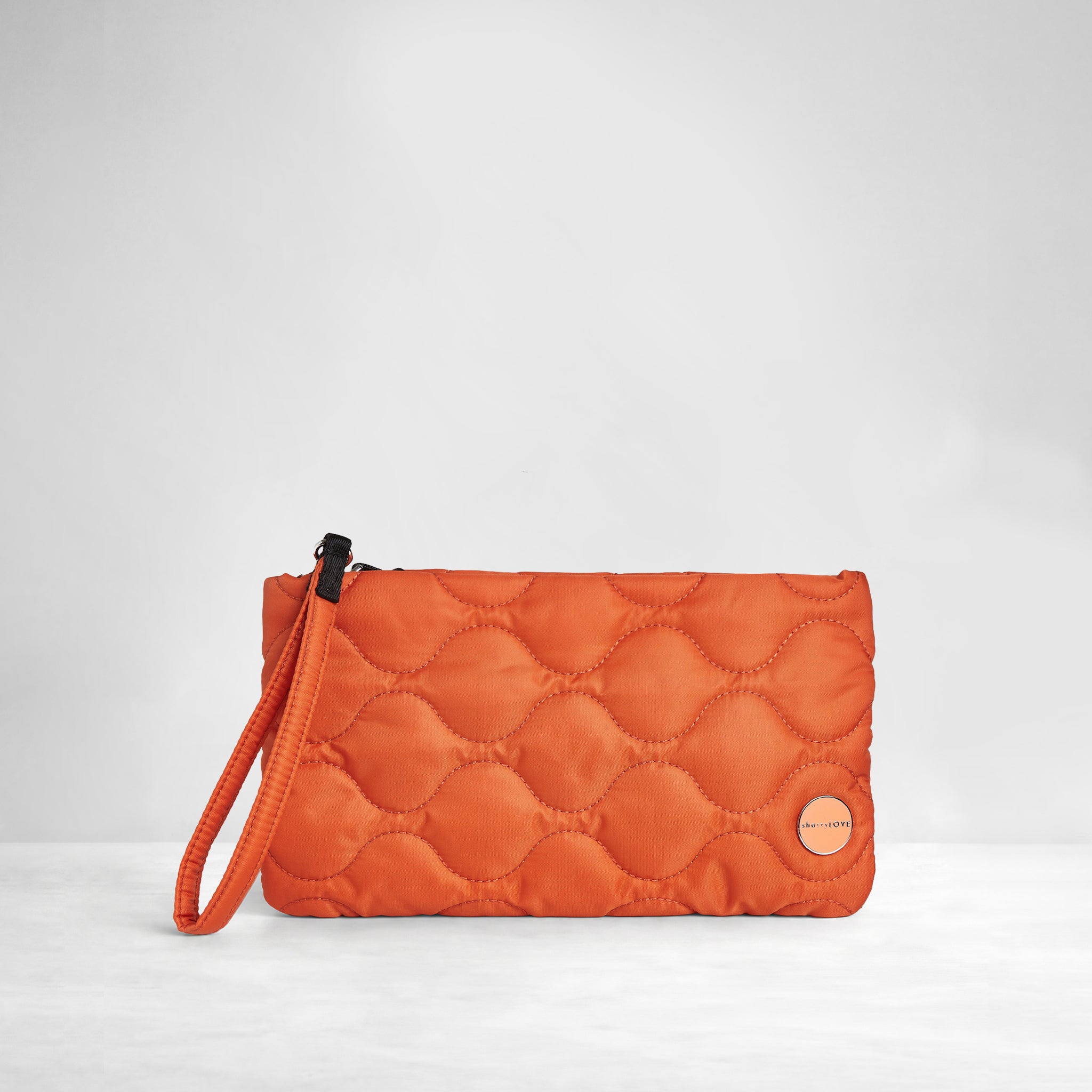 shortyLOVE cleo wristlet clutch in orange; front view against white background.