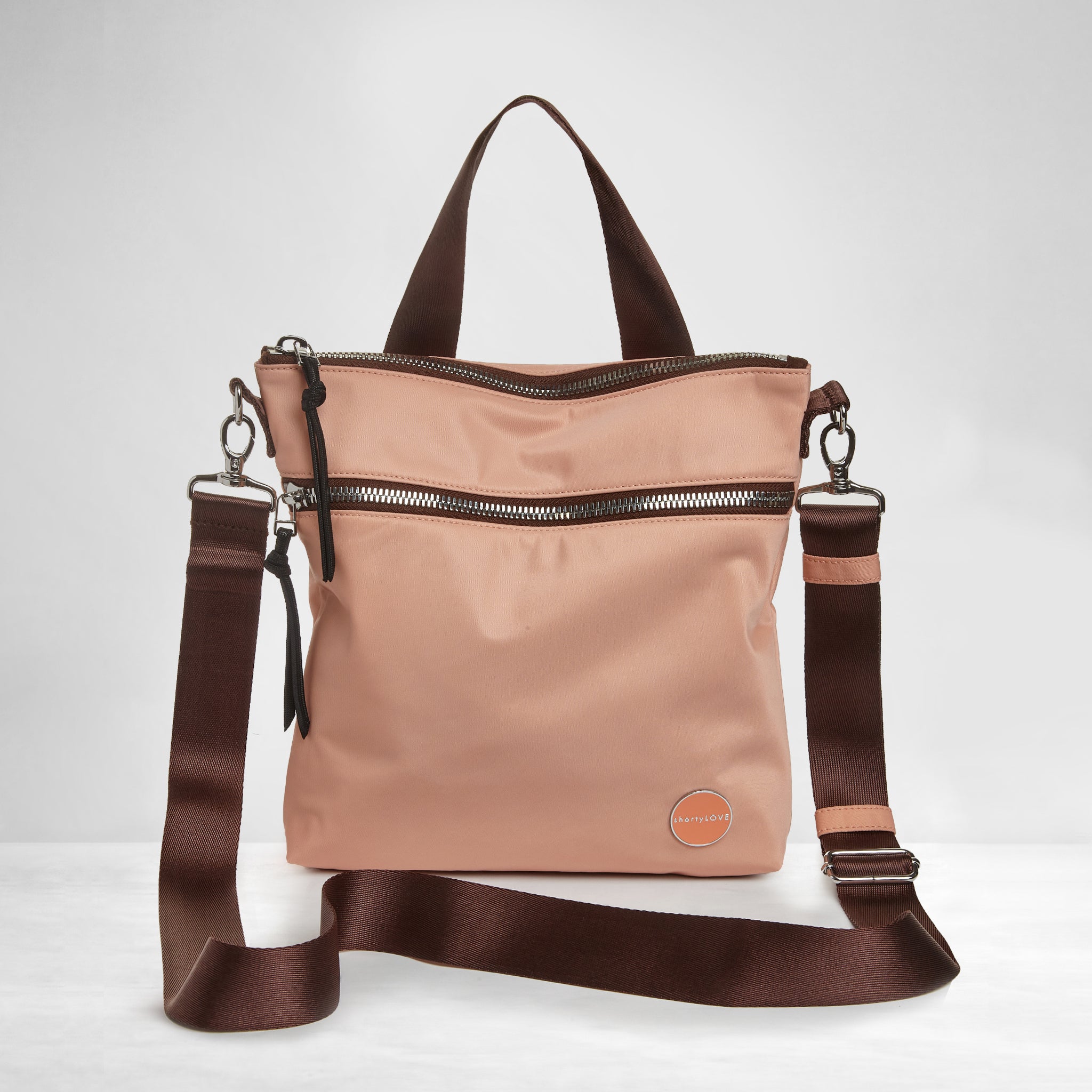 shortyLOVE amuse medium sized crossbody bag in dusty peach; front view against grey background.