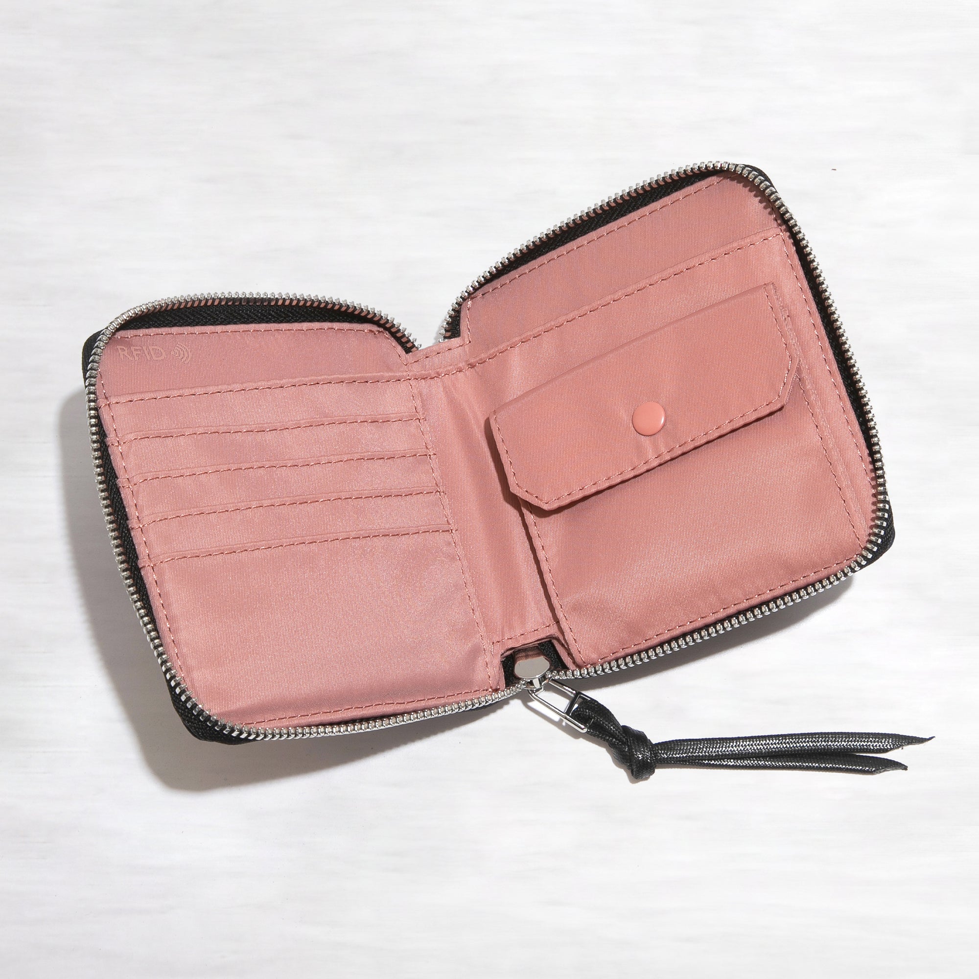 shortyLOVE merchant small wallet in black; top-down view showing interior pink lining against white background.