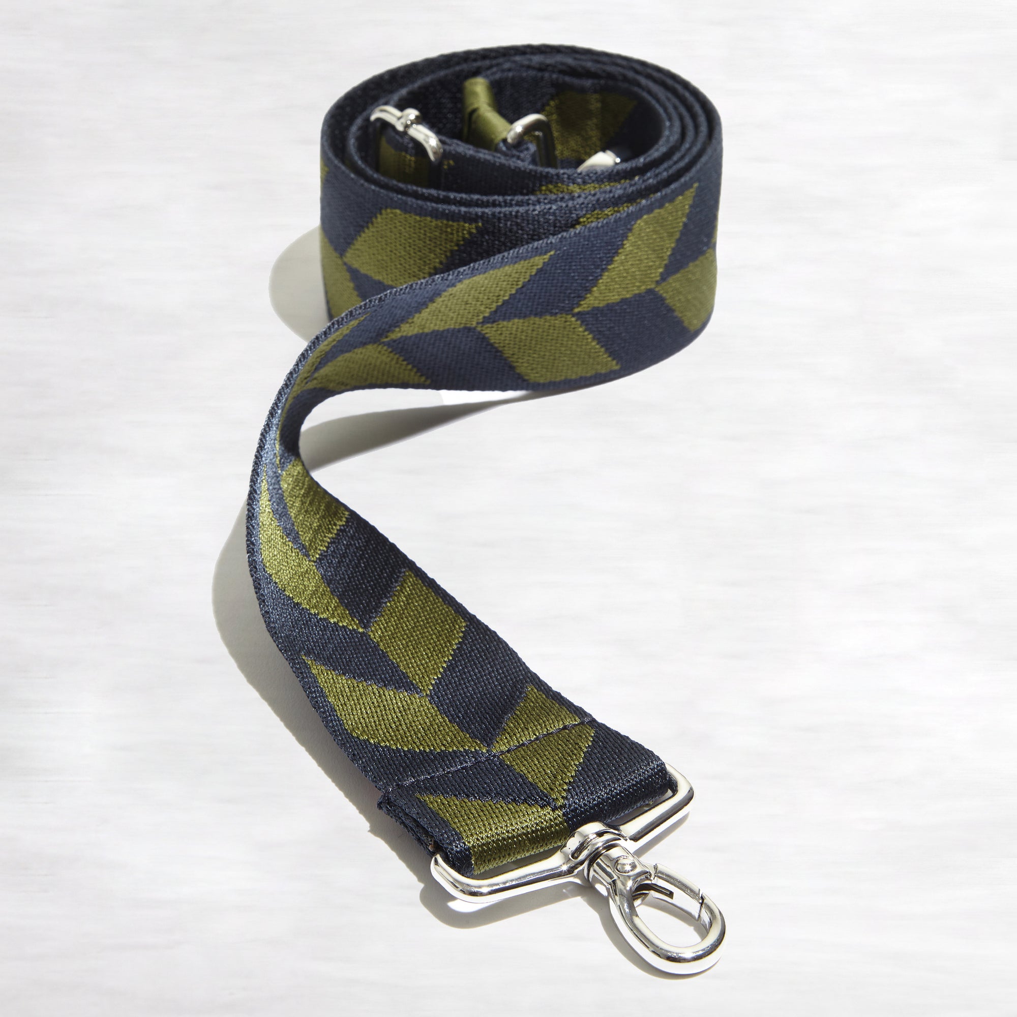 shortyLOVE boardwalk strap in arrow design in midnight/sage; top view front view rolled against white background.