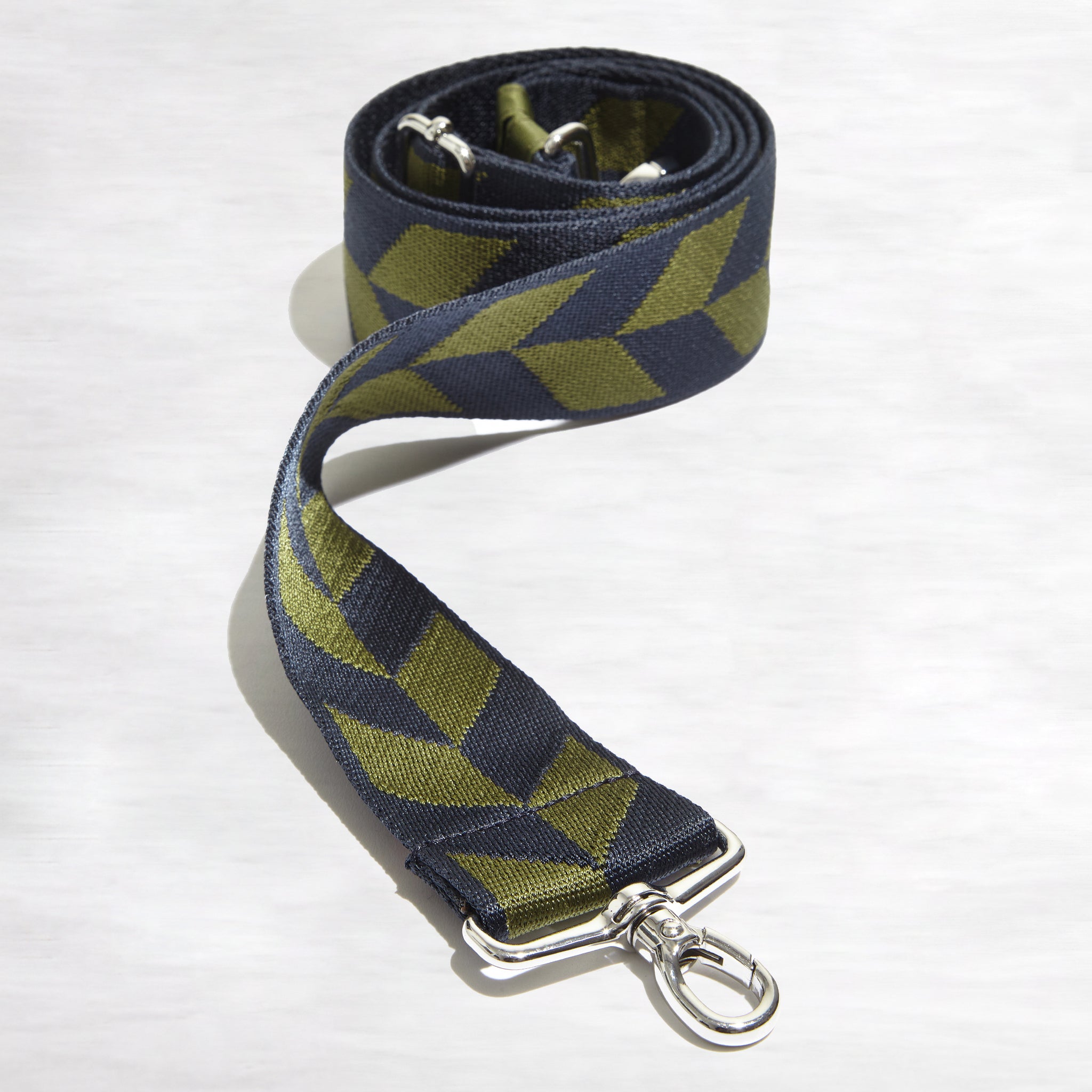 shortyLOVE boardwalk strap in arrow design in midnight/sage; top view front view rolled against white background.