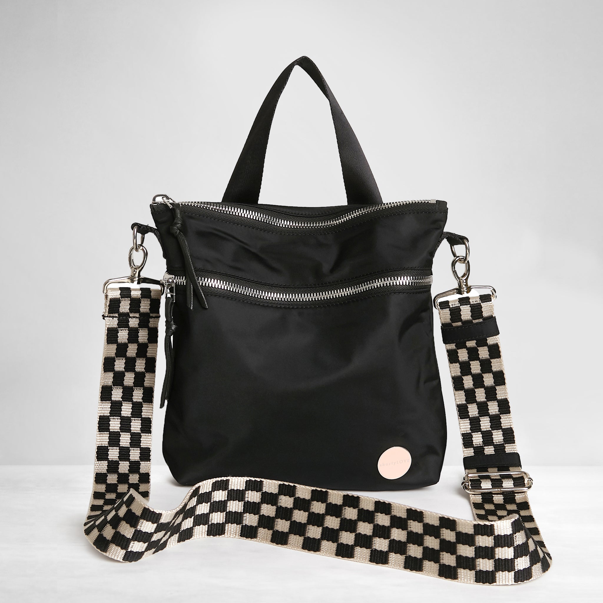 shortyLOVE boardwalk strap in black/white checker; shown with amuse bag in black.