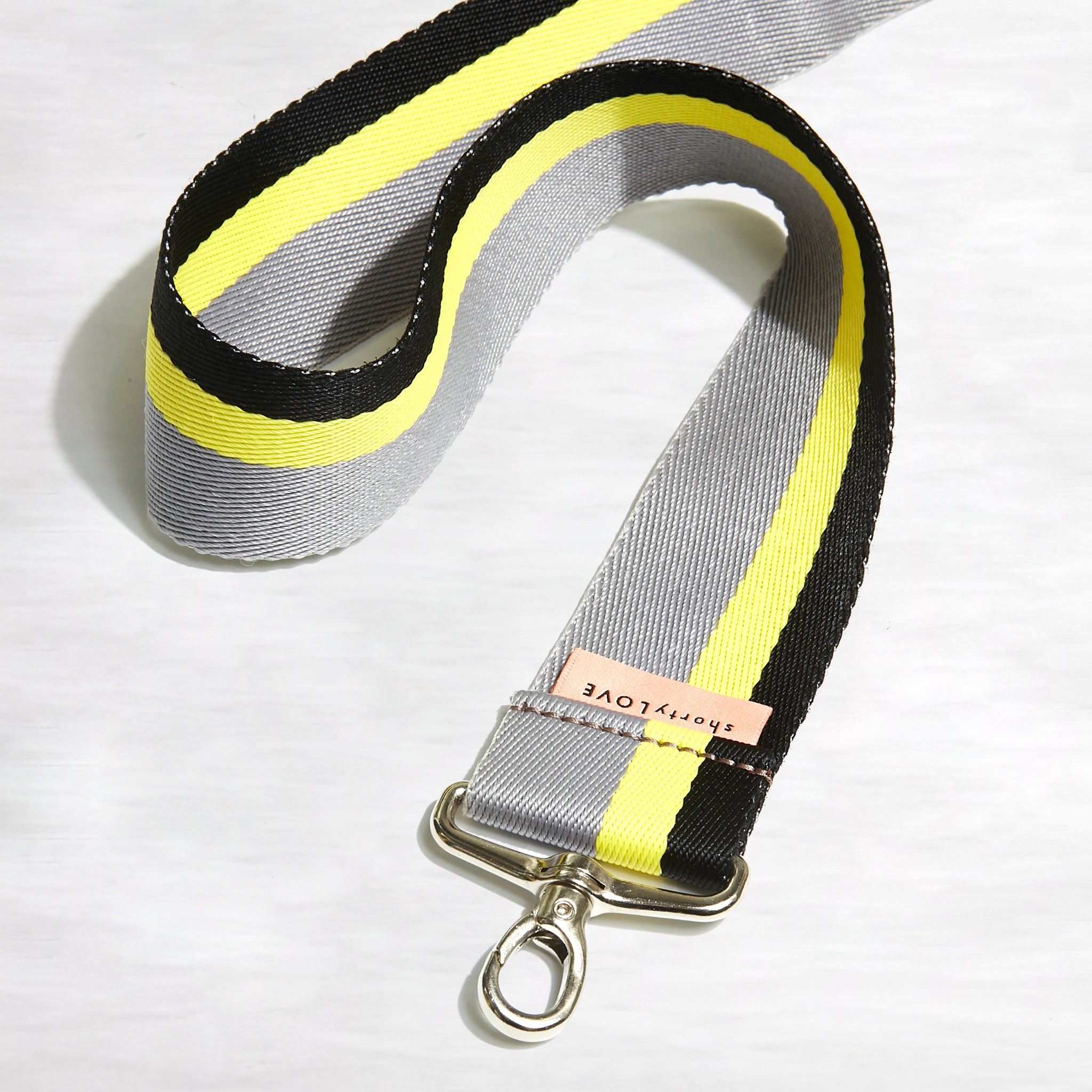 shortyLOVE boardwalk strap in grey/yellow/black; coiled close up view against white background.