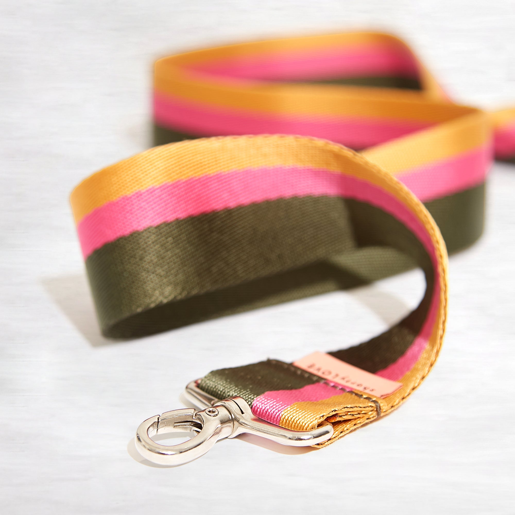 shortyLOVE boardwalk strap in green/yellow/fuchsia; close up view against white background.
