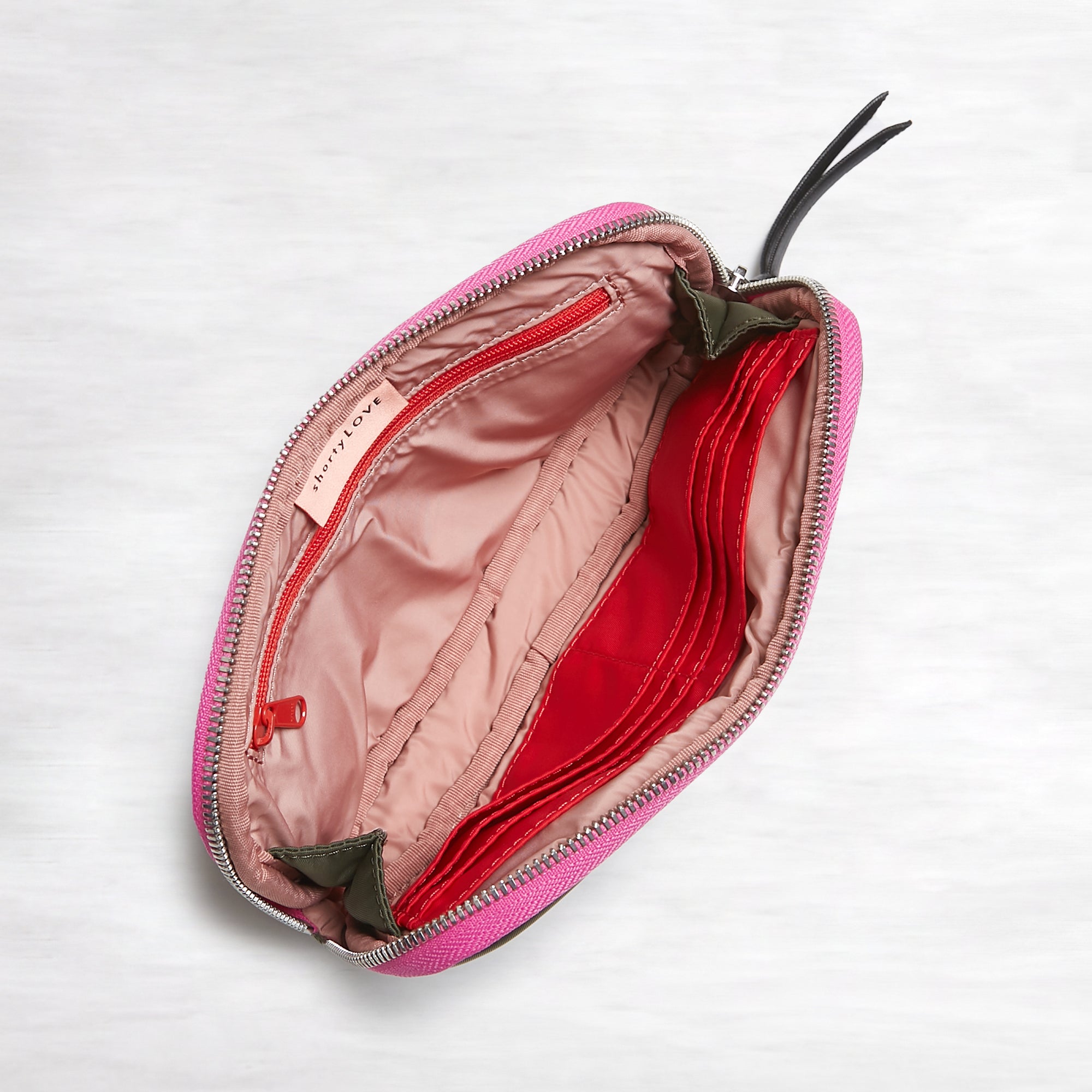 shortyLOVE jetty clutch/wallet in army green; top-down view showing interior pink lining against white background.