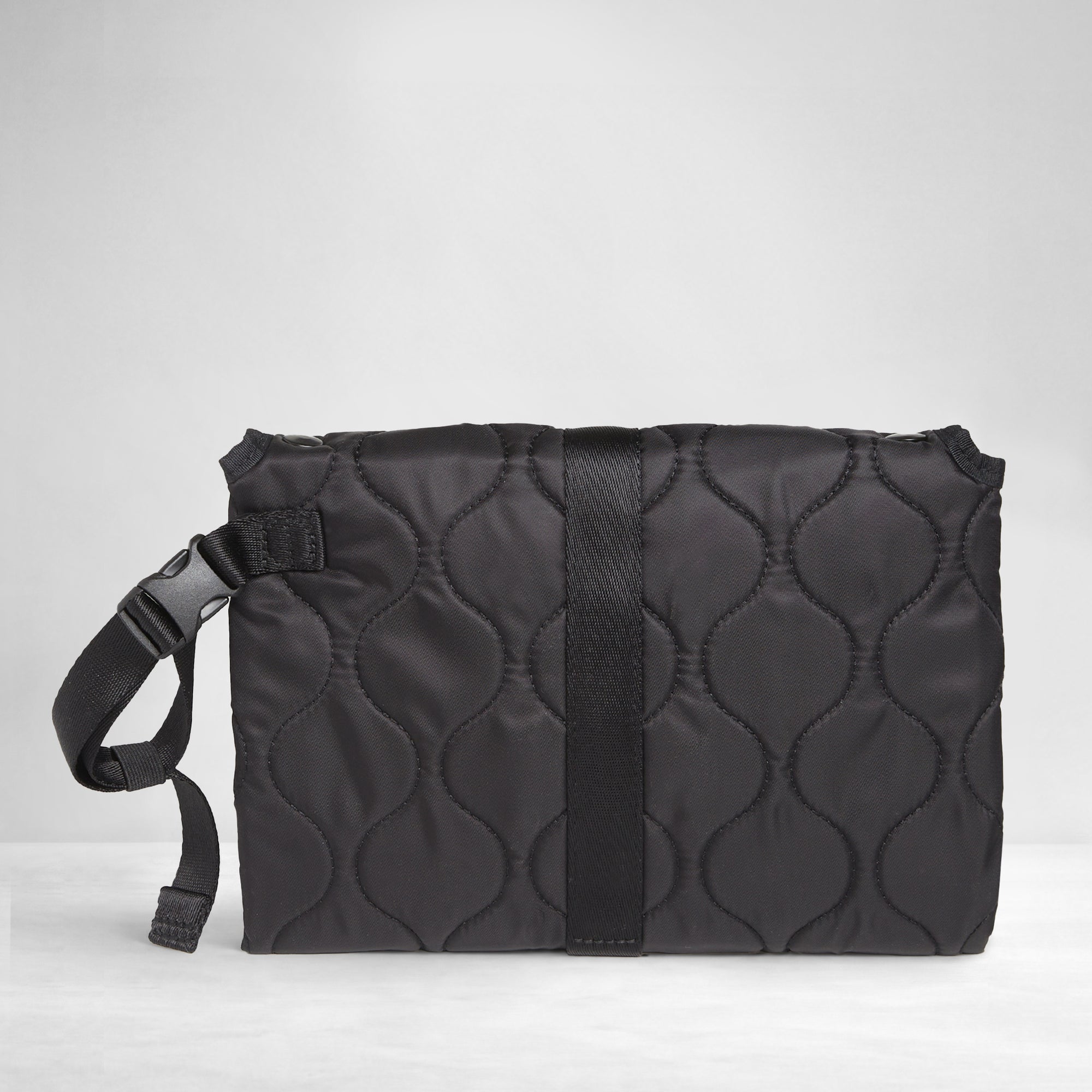 Black quilted diaper changing mat folded and closed - back view on a white background