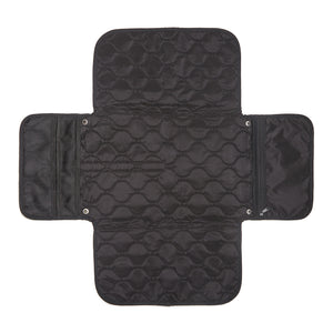 Black quilted diaper changing mat with multiple compartments on a white background