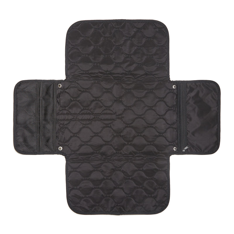 Black quilted diaper changing mat with multiple compartments on a white background