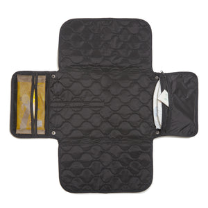 Black quilted diaper changing mat with multiple compartments on a white background