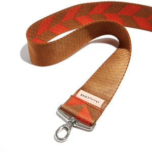 shortyLOVE boardwalk strap in arrow design orange/tobacco; snaking against white background.