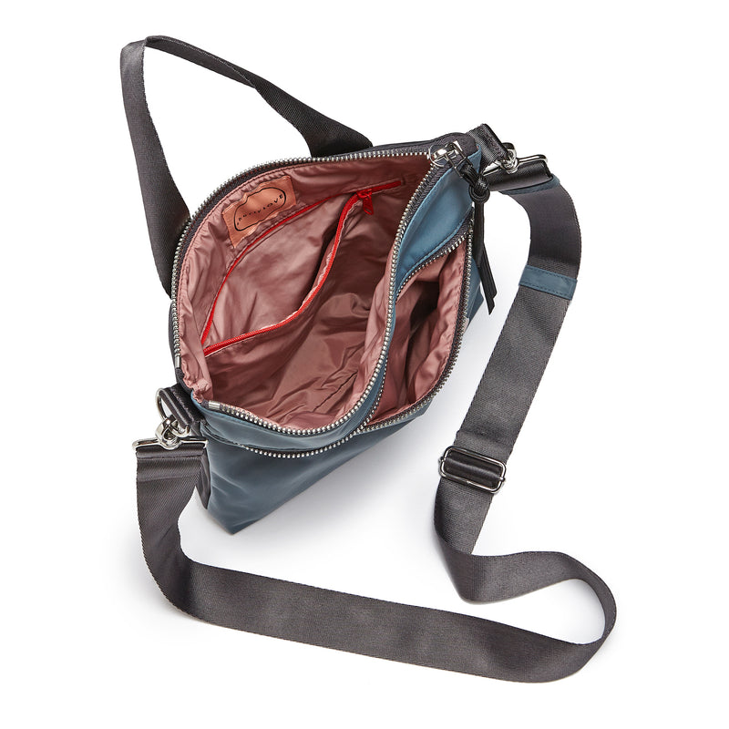 shortyLOVE amuse medium sized crossbody bag in steel blue/charcoal; top-down view showing interior steel blue/charcoal lining against white background.