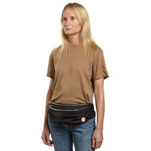shortyLOVE arcade belt bag in black; on model in tan t-shirt and jeans against white background.