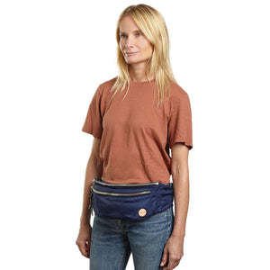 shortyLOVE arcade belt bag in navy; on model in rust t-shirt and jeans against white background.