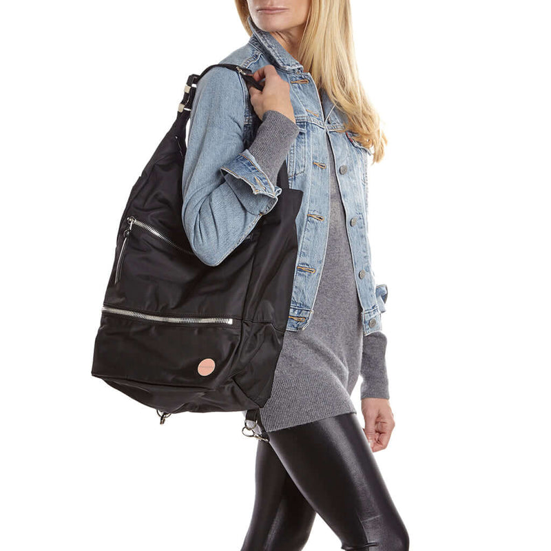 shortyLOVE boxer backpack bag in black; on model in blue jean jacket and black leggings against white background.