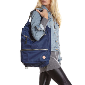 shortyLOVE boxer backpack bag in navy; on model in blue jean jacket and black leggings against white background.