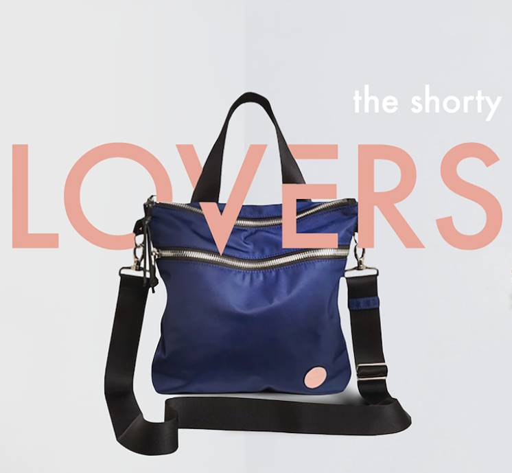 Navy amuse crossbody bag with the copy "the shorty lovers" artistically displayed with the bag.