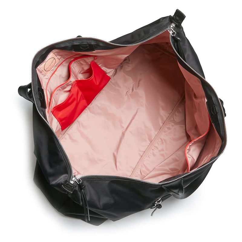 shortyLOVE friday weekender travel bag in black; top-down view showing interior pink lining against white background.