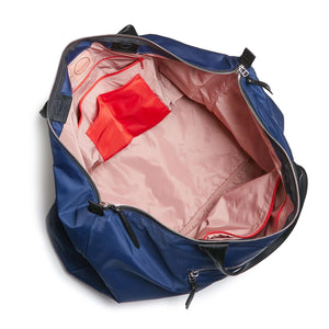 shortyLOVE friday weekender travel bag in navy; top-down view showing interior pink lining against white background.