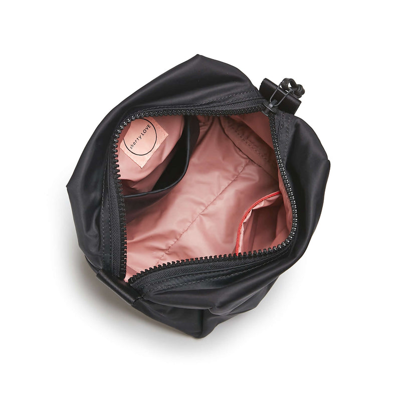 shortyLOVE stevie cosmetic bag in black; top-down view showing interior pink lining against white background.