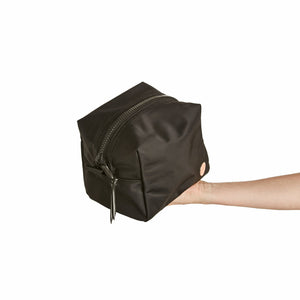 shortyLOVE stevie cosmetic bag in black; hand held by model.