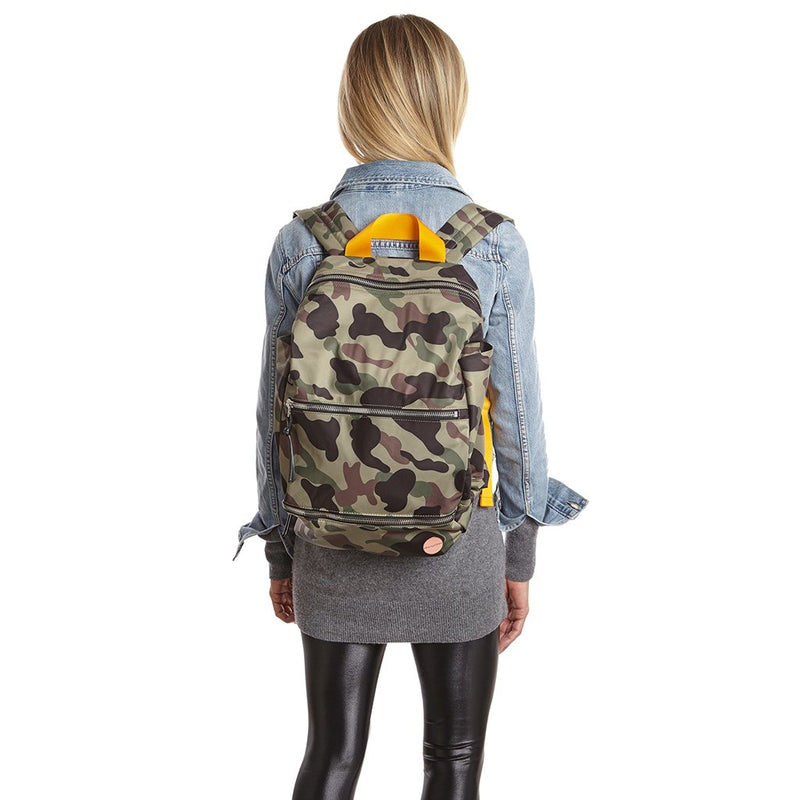 shortyLOVE boxer backpack bag in green camo; on model in blue jean jacket and black leggings against white background.