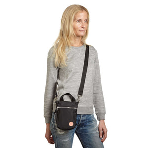 shortyLOVE shorthand crossbody phone bag in black; on model in grey sweatshirt and jeans against white background