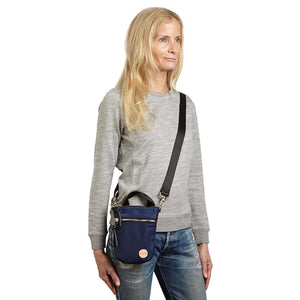shortyLOVE shorthand crossbody phone bag in navy; on model in grey sweatshirt and jeans against white background.