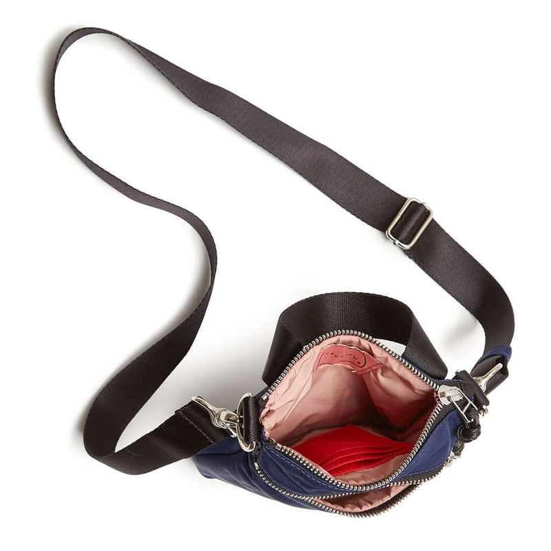 shortyLOVE shorthand crossbody phone bag in navy; top-down view showing interior pink lining against white background.