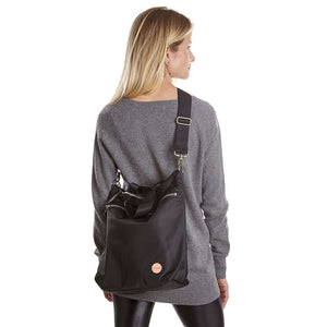 shortyLOVE wonder large crossbody/messenger bag in black; on model in grey long sleeve sweater and black leggings against white background.