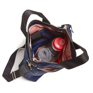 shortyLOVE wonder large crossbody/messenger bag in navy; top-down view showing interior pink lining against white background.